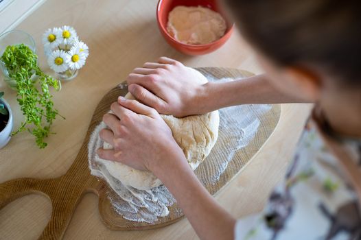 arial shot of a person kneading bread in a kitchen