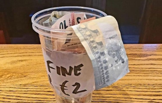 photo of plastic cup with money coming out of it