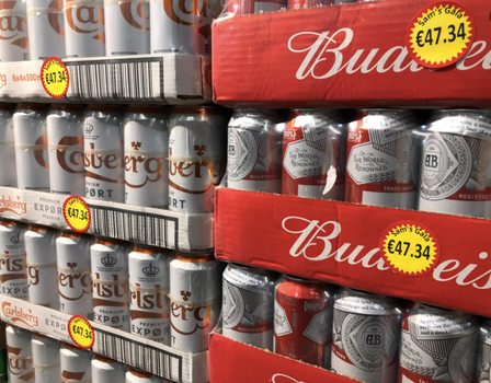 slabs of carlsberg and budweiser cans stacked on top of one another, with €47.34 price tags
