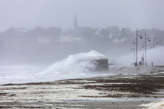 image of waves crashing and mist during a storm in ireland