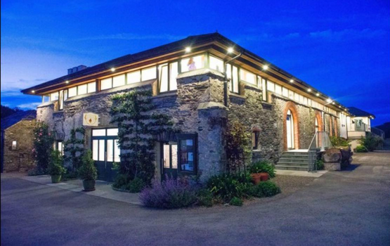 exterior of the grainstore building in ballymaloe at dusk