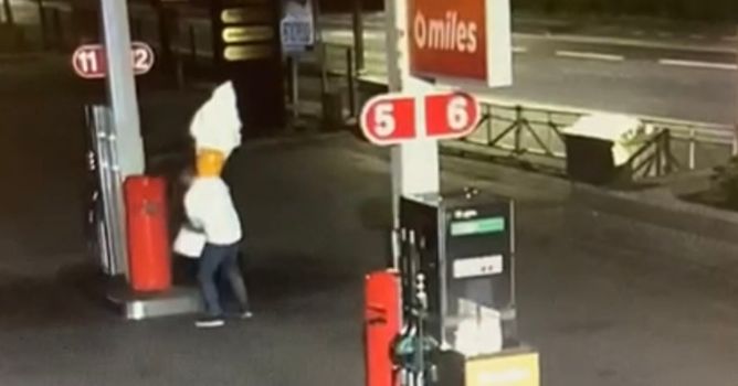 cctv image of a novelty sized ice cream cone sign being carried away from a garage