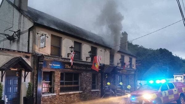 Waterloo Inn pub in Blarney with visible fire damage, fire brigade parked outside