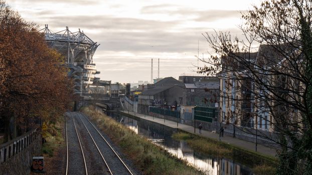 train tracks beside the Royal Canal, Croke Park can be seen behind a tree in the background
