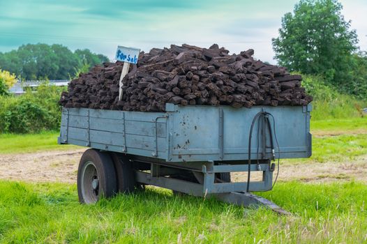 trailer in a field full of turf, with a small "for sale" sign sticking out at the side