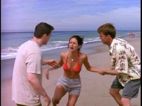 Joey, Monica and Chandler from Friends on a beach - Monica is crying in pain after being stung by a jellyfish