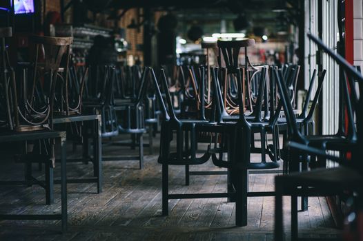 closed, empty restaurant with chairs stacked on top of tables