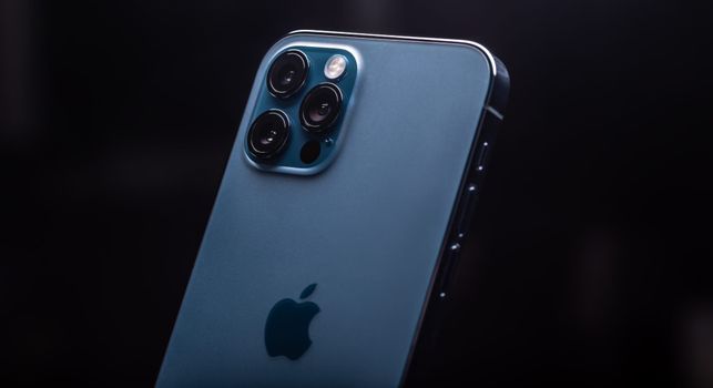the back of a blue iphone 13 pro