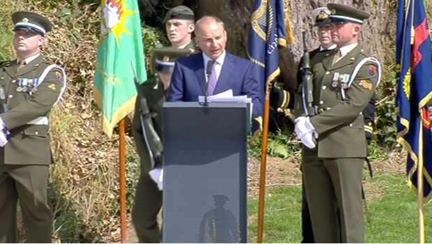 Micheal Martin giving a speech wit defence soldiers in the background