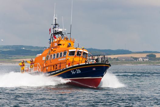 RNLI boat travelling at speed through water