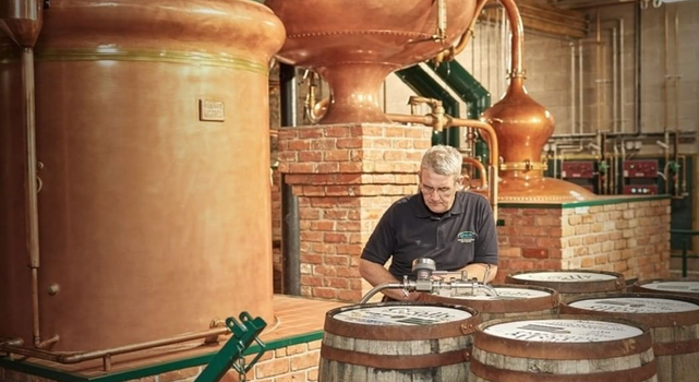 man working at a whiskey distillery