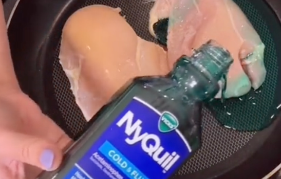 overhead shot of someone pouring NyQuil cough medicine over chicken breasts