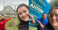 Irish couple take a photo beside all 32 county signs in Ireland