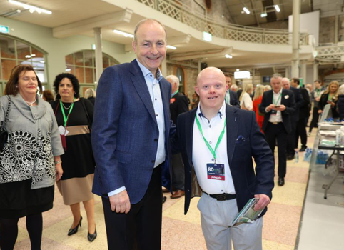 Fintan Bray posing for a picture beside taoiseach Micheál Martin at a political event