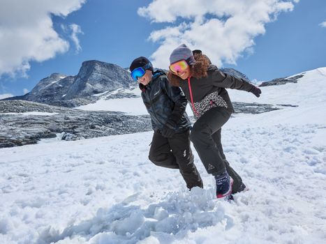 two kids on a ski slope in full ski gear