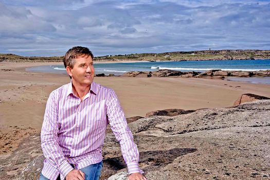 daniel o'donnell looking out into the distanceon a beach