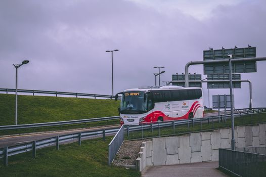 an Irish bus coming onto a motorway