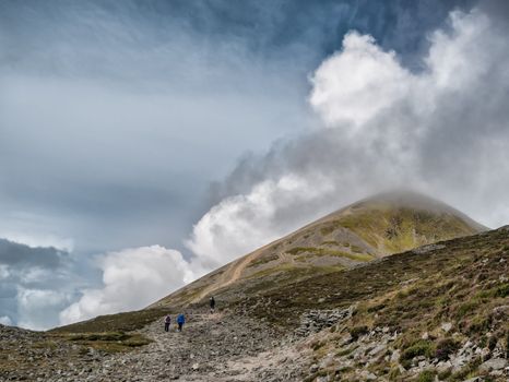 two people walking along a path towards croagh patrick