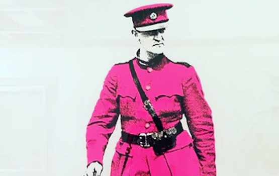 A print of Michael Collins wearing a pink suit and hat