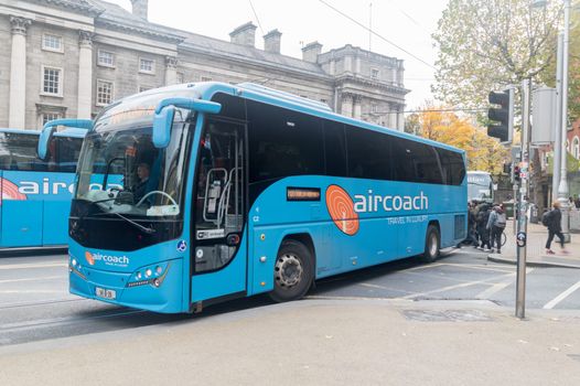 an aircoach pulling into a street in dublin