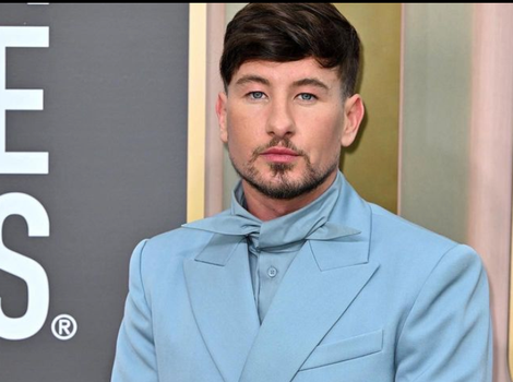 barry keoghan in a blue suit on a red carpet